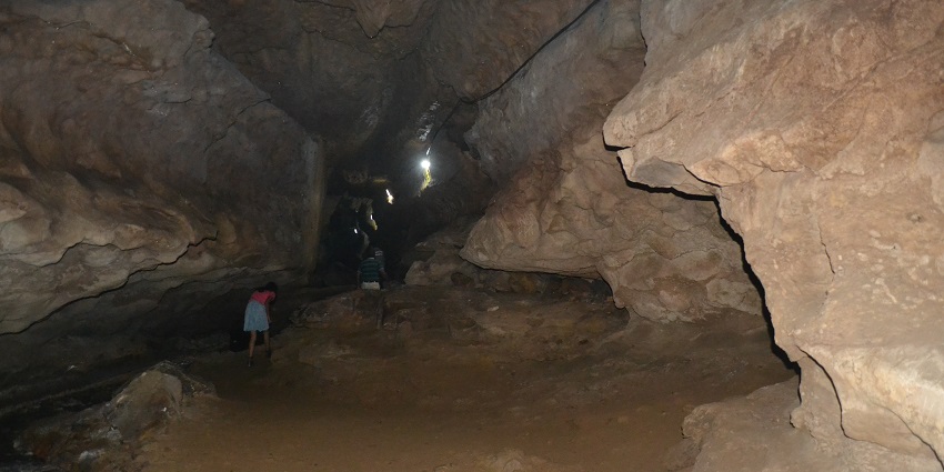 A picture of a cave taken from the inside showing limestones at the walls