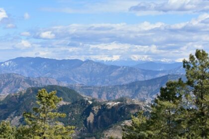 A distant view of the Himalayan range of mountains on a bright day