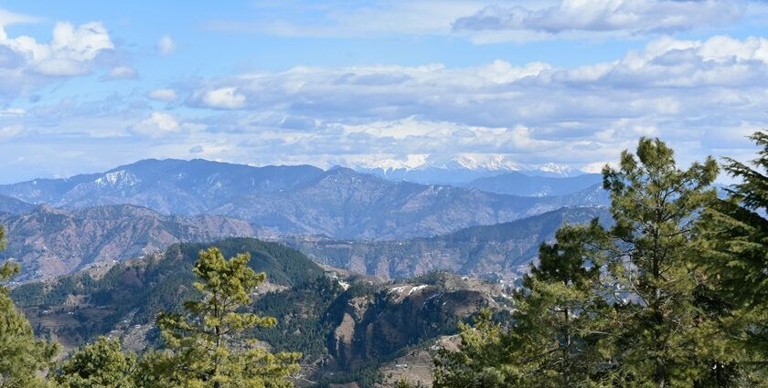 A distant view of the Himalayan range of mountains on a bright day