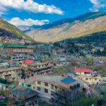 The beautiful Kullu town showing the houses along with mountains in the background