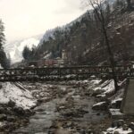 A scenic image of an iron bridge over a stream of river near Kalath Hot Spring.