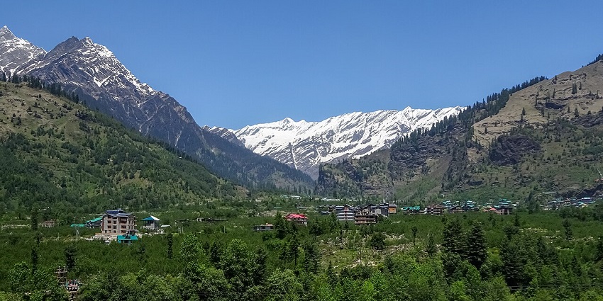 Scenic view of Kullu Valley from Manu temple with lush greenery and mountains near Manali, India.