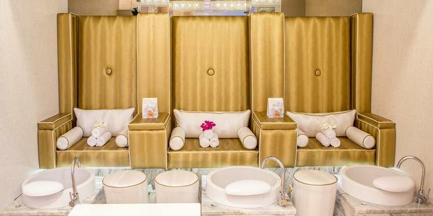 Brown chair with white pillows placed in a cozy, well-lit indoor setting.