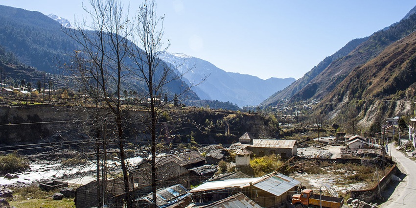A picture of the scenic hill town of Lachung with distant mountain peaks visible in the background