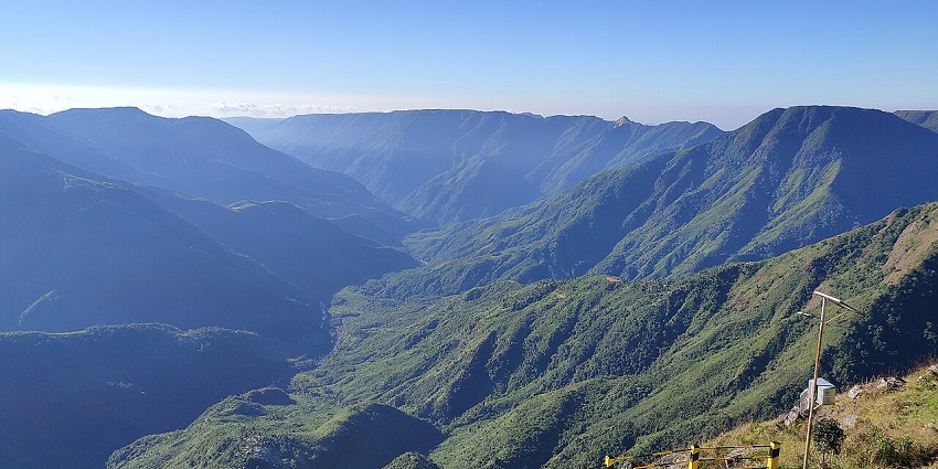 Laitlum Canyon with vast, dramatic cliffs and a panoramic view of rolling green hills.