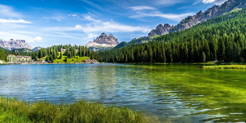 Scenic snapshot of a green lake amidst the hills and lush dense forest across the resort