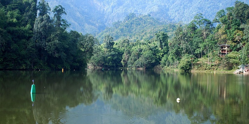 Ganga Lake surrounded by hills, with clear, serene waters reflecting the landscape.