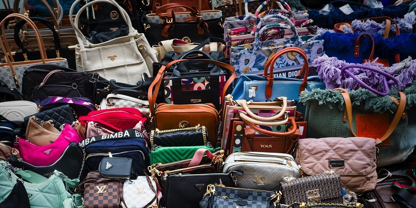 A landscape of a pile of colourful bags kept beside each other during the daytime.