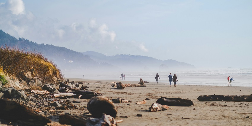 A breathtaking view of a beach in Cambodia with sandy shores and people during the day.