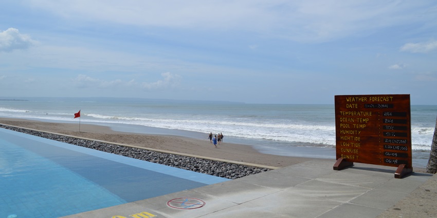 A picture of a poolside beach with scenic views of the blue sky in the background