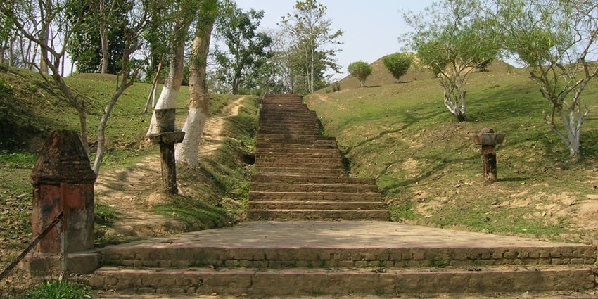 A staircase of a Maidam with trees on both sides