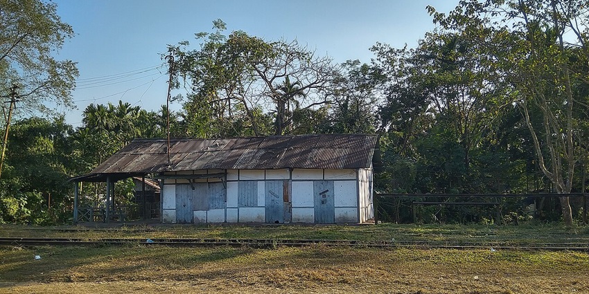 A scenic view of Lekhapani featuring a quaint village housing rugged houses and trees.
