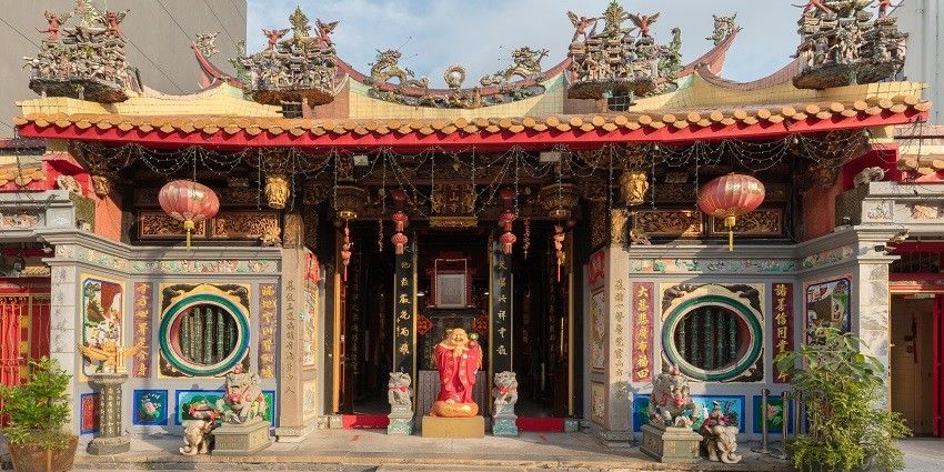 A picture of a monastery in Singapore with idols standing at its entrance