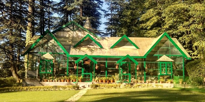 A frontal view of the Army Heritage Museum with a big garden in front