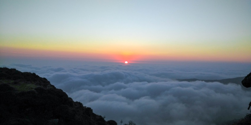 The view of an infinite layer of clouds at the top of this famous peak in India and Nepal.