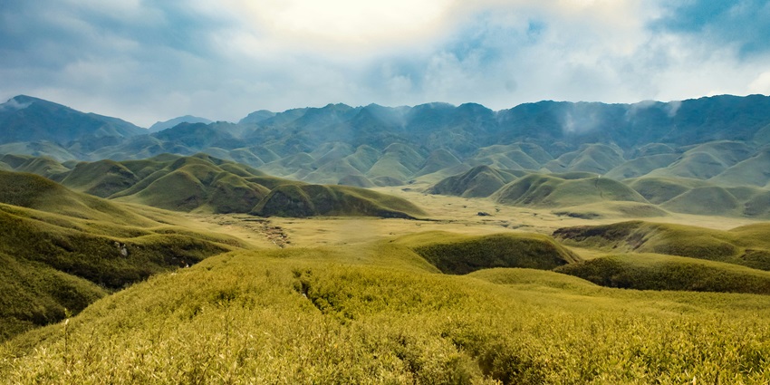 A view of rolling meadows and lush green hills near the Intanki National Park, Nagaland
