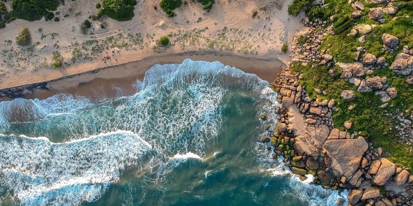 The Galle Fort, a popular tourist attraction, touches the serene waters of the ocean.