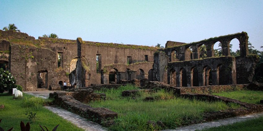 A breathtaking view of an ancient monument surrounded by green lawns during the day.