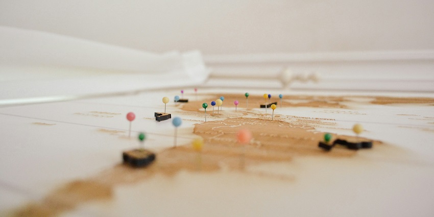 A view of focus photography on a map with pins on it to show different locations.