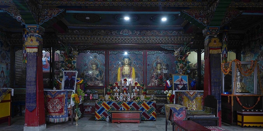 A mesmerising view of a Monastery in Sikkim with idols and photos of gods inside it.