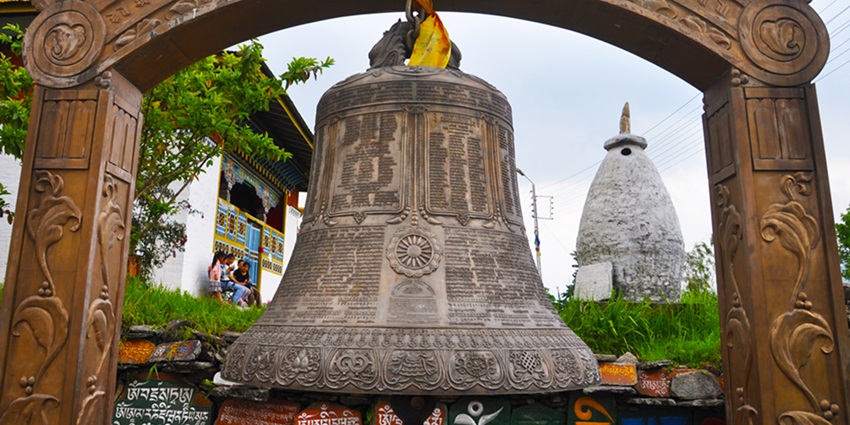 A mesmerising view of an enormous bell in front of a monastery in Sikkim, a must-see.