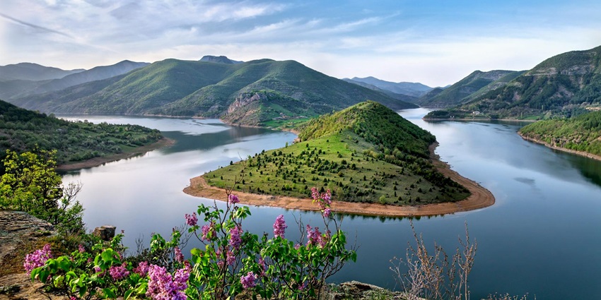 Unique floating islands, serene waters, and lush surroundings, offering natural beauty.