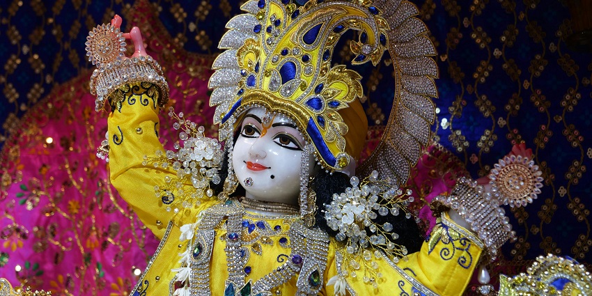 Lord Krishna statue adorned with traditional garments, symbolising divine grace.