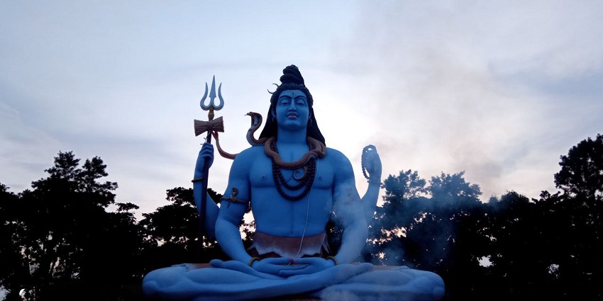 Shiva idol, set against a backdrop of lush greenery - summer festivals in West Bengal.
