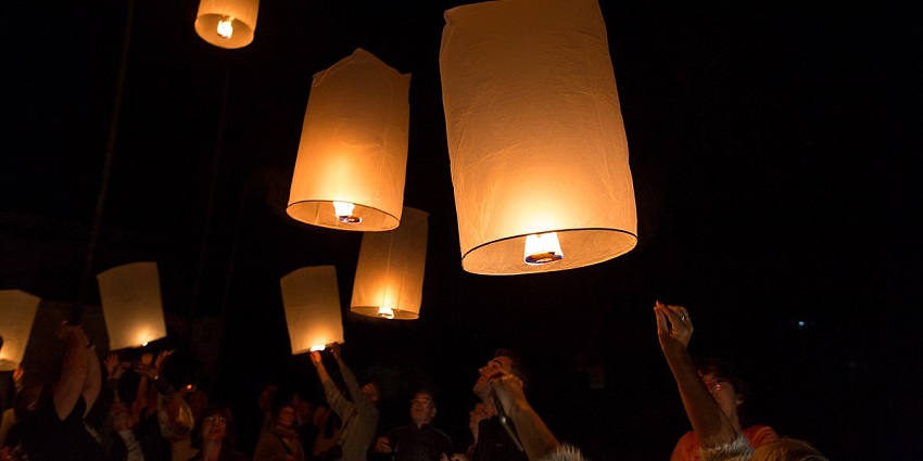 A captivating view of lanterns lighting up the night sky during Loy Krathong Festival