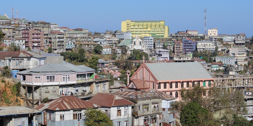 Lunglei town in Mizoram, buildings on hills lush green surrounded and clear blue sky.