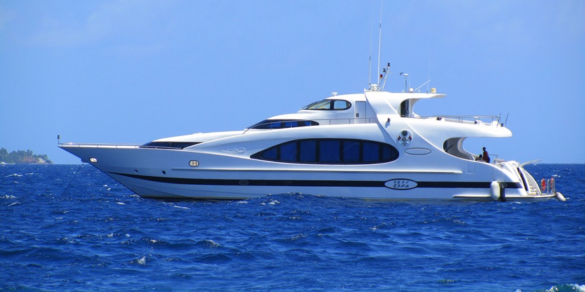 A picture of a white cruise ship sailing in the blue sea on a sunny day, one of the best experiences in Dubai