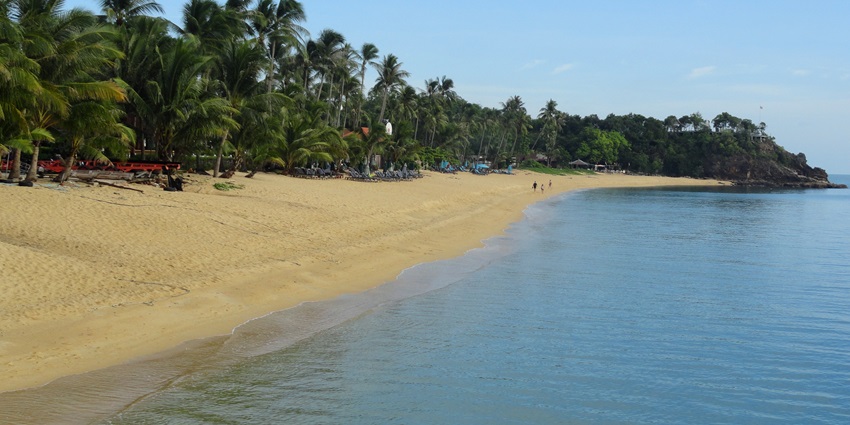 Picturesque Maenam Beach featuring golden sands, calm waters, and tropical palms.