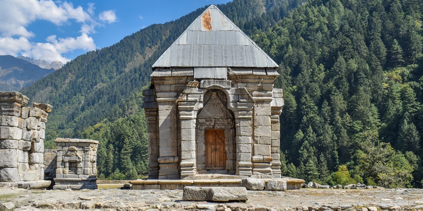 Ancient stone temple ruins at Naranag, Jammu and Kashmir, surrounded by scenic mountains
