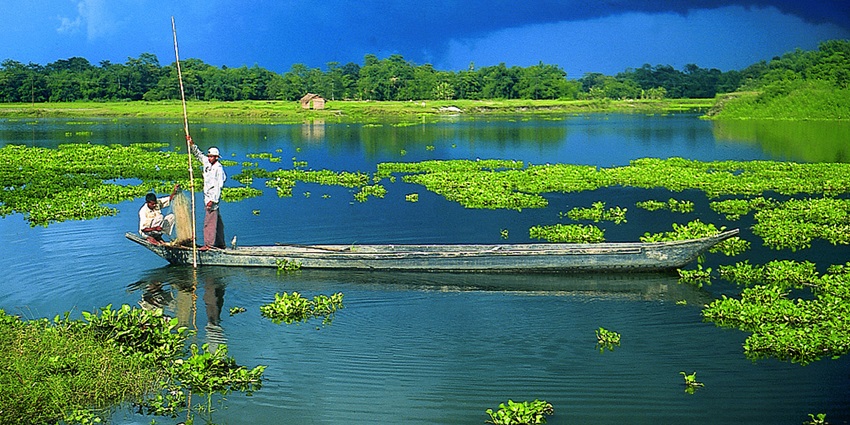 Boats cruising in azure waters of Majuli Island, a hotspot near Bhairabkunda Picnic Place.
