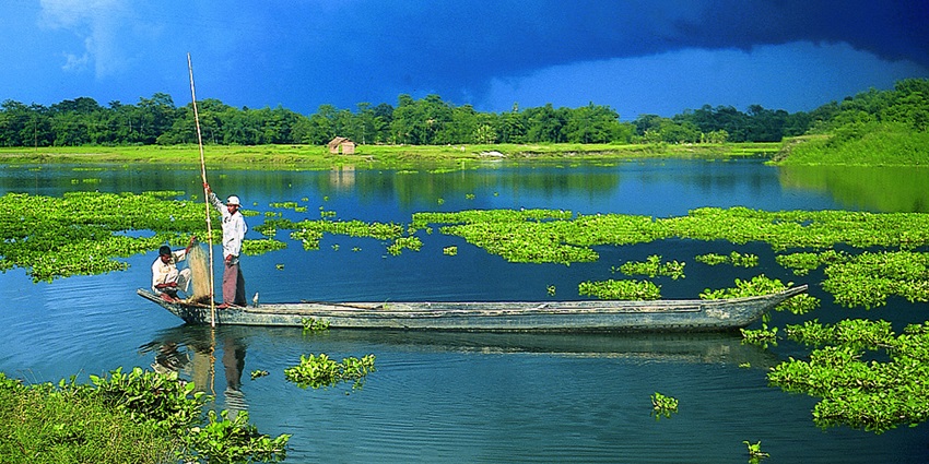 Enchanting snapshot of a fisherman on the boat somewhere in Majuli Island in Assam