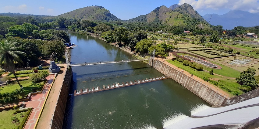 View of Malampuzha Dam in Palakkad, Kerala, surrounded by lush greenery and mountains.
