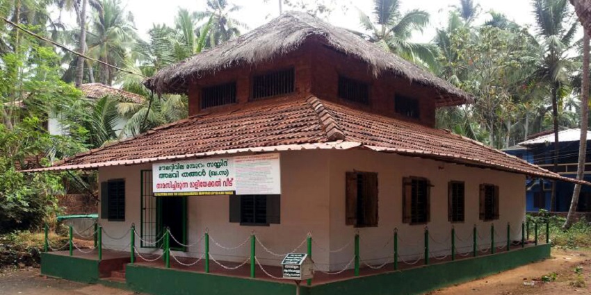 A breathtaking view of a red-roofed hut in Mamburam with lush green surroundings.