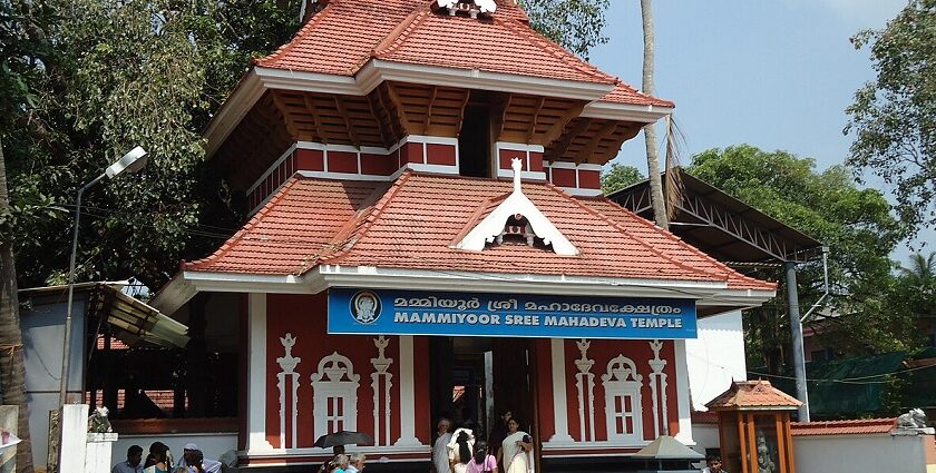 Explore the intricate woodwork and traditional architecture of the Shiva temple in Kerala.