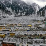 An aerial view of Manali covered in snow during winters, presenting a spectacular view.