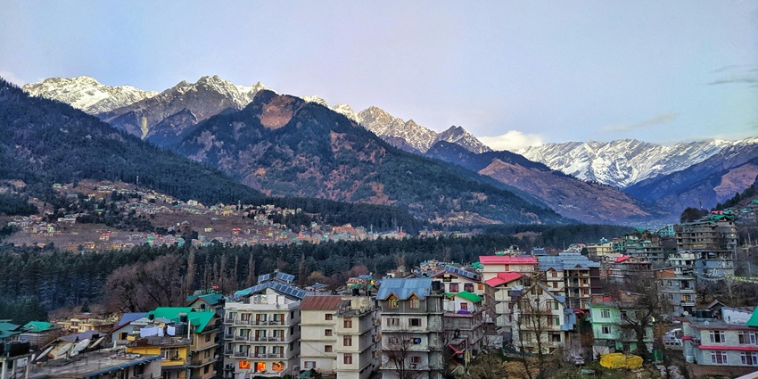 Beautiful image of the scenic city covered in the desne snow fall and forest