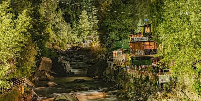 A breathtaking view of a sparkling river flowing through a lush green valley in Manali.