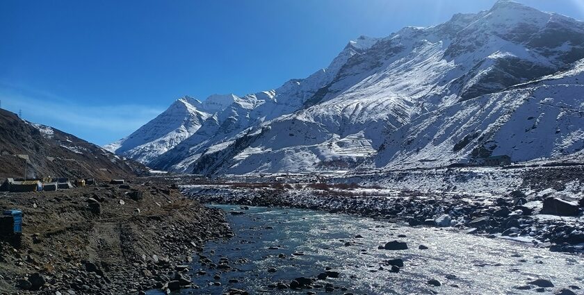 A picture of a hill station covered in snow during winter season under a bright sun