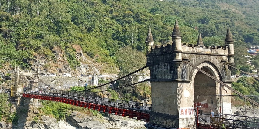 Victoria Suspension Bridge in Mandi, a historic structure spanning the Beas River with scenic surroundings.