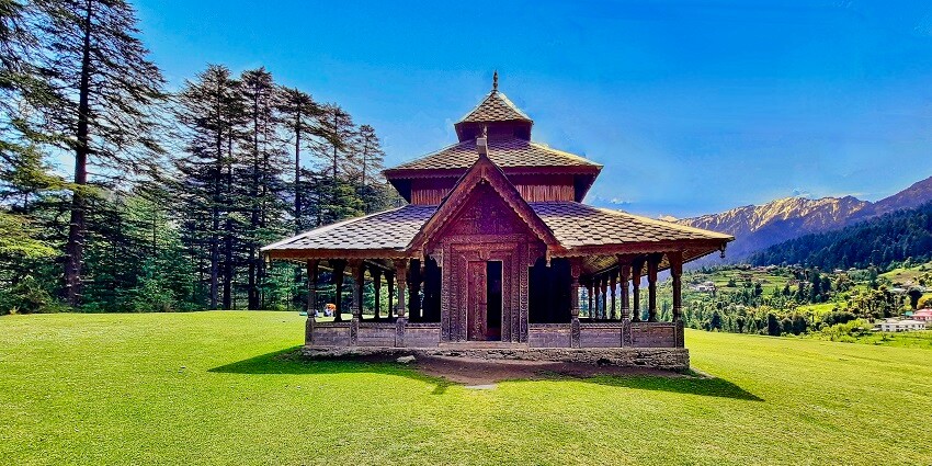 Beautiful image of a hindu temple in the meadows of Manali near the waterfalls