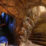 A picture of a cave system with 2 entrances and a big interior, clicked from the inside of the cave