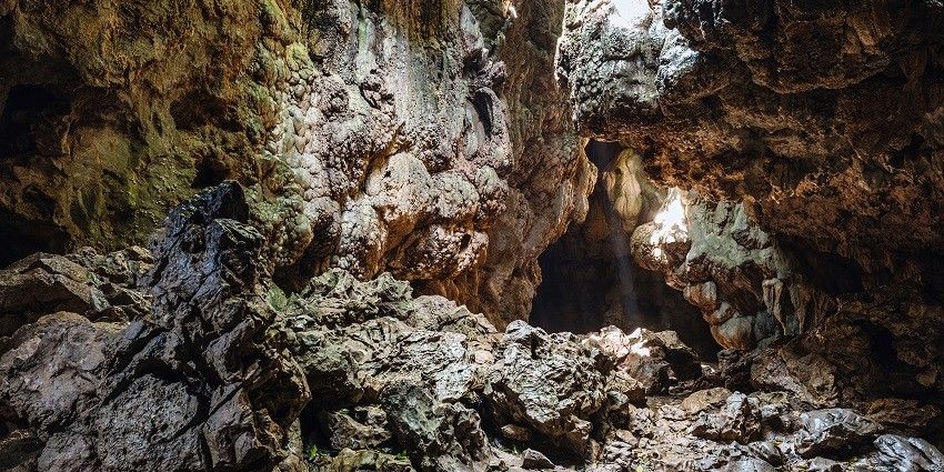 A picture of a cave with tall, rocky walls, taken from the inside of the system
