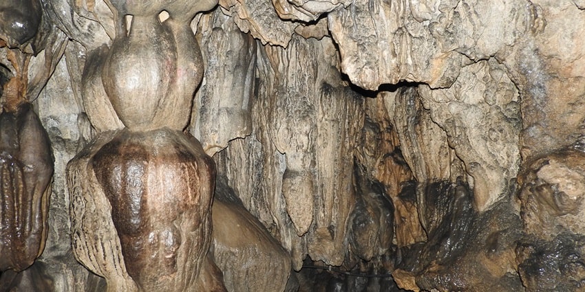A spellbinding view of the historical Mawsmai Cave with intricate limestone formations.