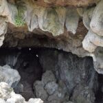 A picture of a cave system in Shillong with a narrow entrance through the rocks