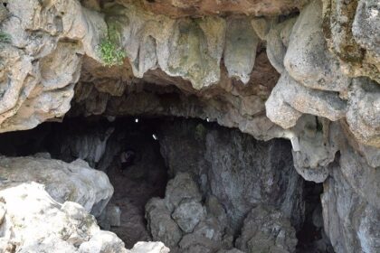 A picture of a cave system in Shillong with a narrow entrance through the rocks