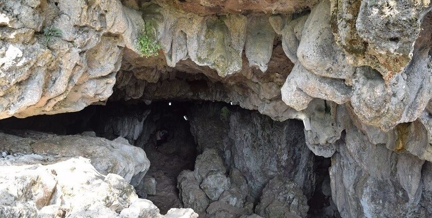 A picture of a cave system in Shillong with a narrow entrance through the rocks